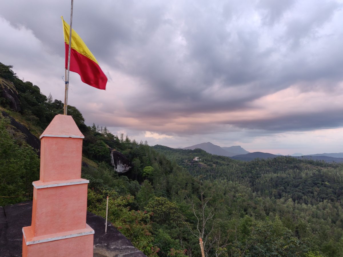 Hilltop shrine above forested hills at dusk, Chikkamagaluru